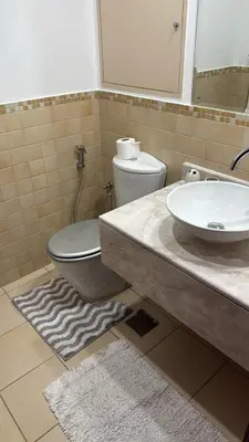 a bathroom with a sink and a toilet and a mirror at Rimal 4 in Dubai
