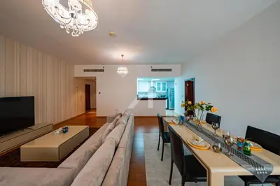 a living room with a large couch and a table at Rimal 4 in Dubai