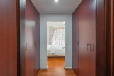 a hallway with two doors with a bedroom in the background at Rimal 4 in Dubai