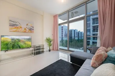 a living room with a tv and a large window at 1BHK Retreat Peaceful & Bright in Dubai