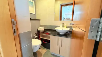 a bathroom with a sink and a toilet at Ocean Heights New 2BDR with full Sea & Dubai Eye view in Marina by Simplex Home in Dubai