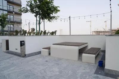 two benches on the roof of a building at Lux Sobha Hartland 1 BR with 5 Star Resort Amenities in Dubai
