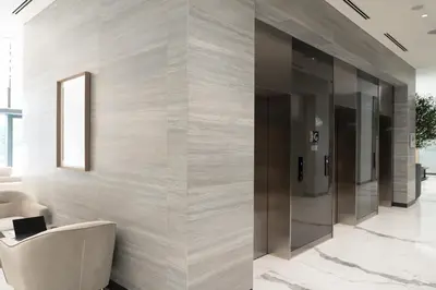a lobby with a wall of glass doors at Lux Sobha Hartland 1 BR with 5 Star Resort Amenities in Dubai