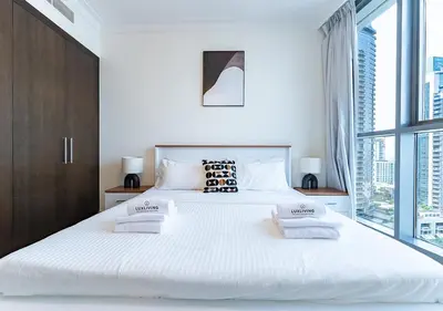 a bedroom with a large white bed with two pillows at Stunning 2 Bedroom at Dubai Creek in Dubai