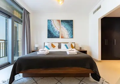 a bedroom with a large bed and a large window at Stunning 2 Bedroom at Dubai Creek in Dubai