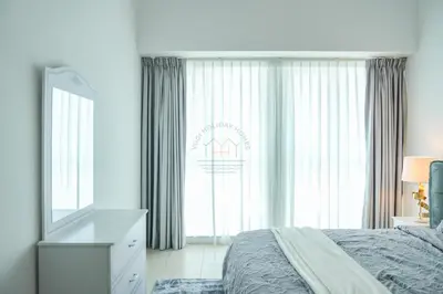 a bedroom with a bed and a dresser and a mirror at Luxury 2BR with Burj and Ocean Views in Dubai