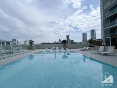 a swimming pool on the roof of a building at Luxury & Comfort 1B at Binghatti Amber & Balcony in Dubai