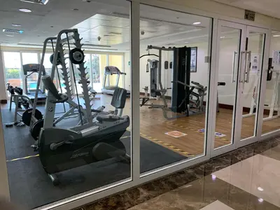 a gym with treadmills and machines in a building at HiGuests - Huge Duplex for Creative Inspiration! in Dubai