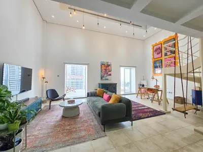 a living room with a couch and a table at HiGuests - Huge Duplex for Creative Inspiration! in Dubai