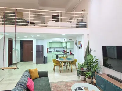 a living room with a couch and a table at HiGuests - Huge Duplex for Creative Inspiration! in Dubai