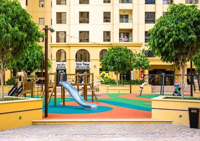 a playground with a slide in front of a building at Beachfront 2BR, Sea & Ain Dubai View, JBR Walk Hosted by Desert City Stays in Dubai