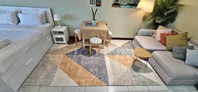 a living room with a bed and a couch at Higuests - Close to METRO Charming Studio with Lake Views in Dubai
