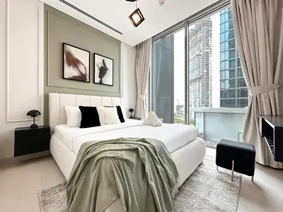 a bedroom with a large white bed and a large window at 2BR Creekfront in Shobha Hartland Modern & Bright in Dubai