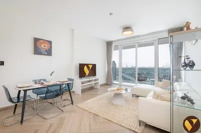 a living room with a table and a couch at Vogue Al Wasl 1 Residences Near Zabeel Park and World Trade Centre, One Bedroom Apartment with Balcony and City View, Access to all Amenities, Walkable to Max Fashion Metro Station in Dubai