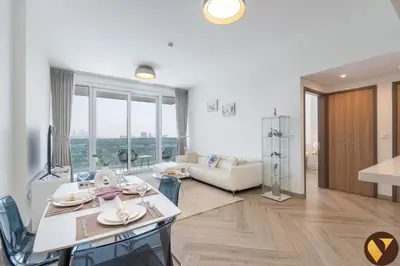 a living room with a table and a couch at Vogue Al Wasl 1 Residences Near Zabeel Park and World Trade Centre, One Bedroom Apartment with Balcony and City View, Access to all Amenities, Walkable to Max Fashion Metro Station in Dubai