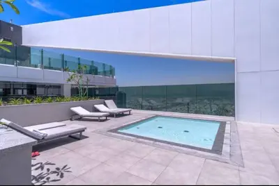 a swimming pool in front of a building at Vogue Al Wasl 1 Residences Near Zabeel Park and World Trade Centre, One Bedroom Apartment with Balcony and City View, Access to all Amenities, Walkable to Max Fashion Metro Station in Dubai