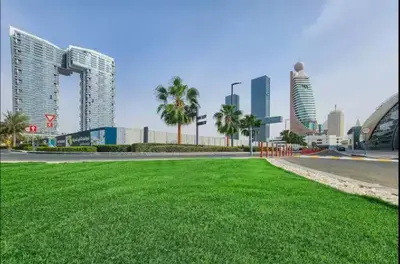 a city with tall buildings and a field of grass at Vogue Al Wasl 1 Residences Near Zabeel Park and World Trade Centre, One Bedroom Apartment with Balcony and City View, Access to all Amenities, Walkable to Max Fashion Metro Station in Dubai