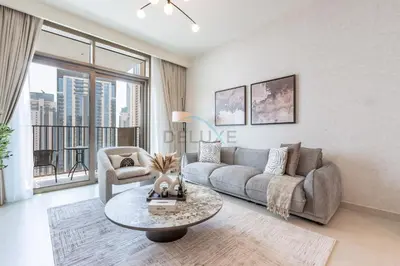 a living room with a couch and a table at Harbourfront Views 1BR, Near Park and Minutes from Festival City Mall, Creek Palace, Dubai Creek Harbour by Deluxe Holiday Homes in Dubai