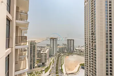 a view of a city from between two tall buildings at Harbourfront Views 1BR, Near Park and Minutes from Festival City Mall, Creek Palace, Dubai Creek Harbour by Deluxe Holiday Homes in Dubai