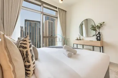 a bedroom with a large white bed with a large window at Harbourfront Views 1BR, Near Park and Minutes from Festival City Mall, Creek Palace, Dubai Creek Harbour by Deluxe Holiday Homes in Dubai