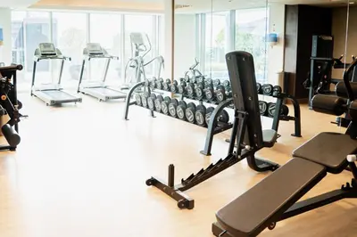 a gym with several treadmills and exercise bikes at Cozy 1BR with Canal Views in Business Bay in Dubai