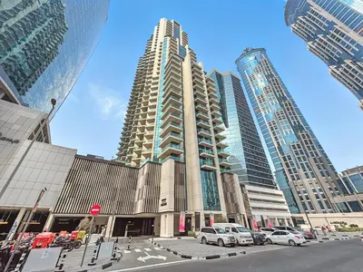 a tall building with cars parked in a city at BLVD - Urban Oasis Missoni 10 - Min to Dubai Mall in Dubai