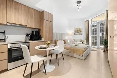 a kitchen and living room with a bed and a table at BLVD - Urban Oasis Missoni 10 - Min to Dubai Mall in Dubai