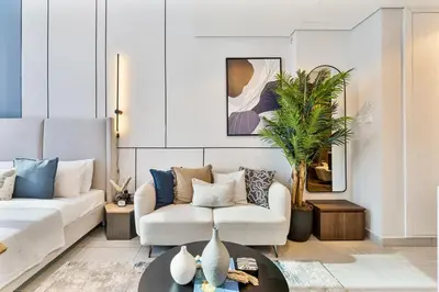 a living room with a couch and a table at Modern Studio - near Dubai Hills Mall - Pool & Gym in Dubai