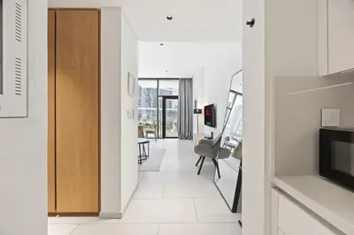 a hallway with a door leading to a living room at Modern Studio in Business Bay, Stylish & Central in Dubai