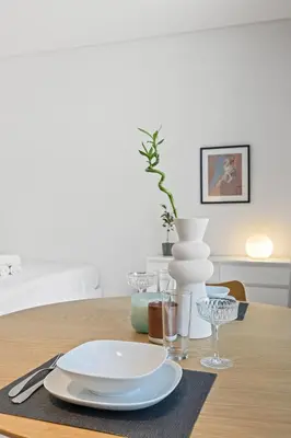a table with a white plate and glasses on it at Modern Studio in Business Bay, Stylish & Central in Dubai