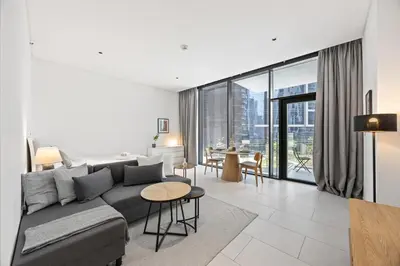 a living room with a couch and a table at Modern Studio in Business Bay, Stylish & Central in Dubai