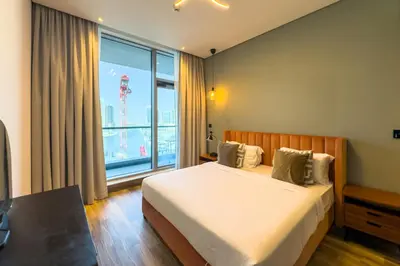 a hotel room with a bed and a large window at Elegant 1BR with Canal Views in Business Bay in Dubai