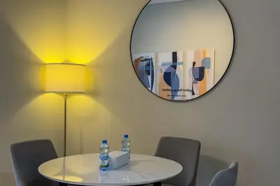 a table with two bottles of water and a mirror at Elegant 1BR with Canal Views in Business Bay in Dubai