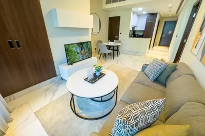 a living room with a couch and a table at Elegant 1BR with Canal Views in Business Bay in Dubai