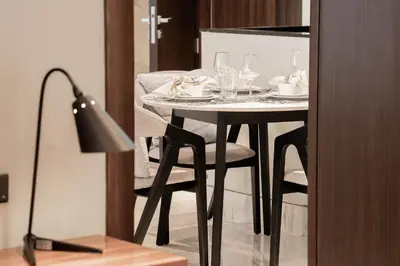 a table with plates and glasses on top of it at Stylish 1BR with Stunning Canal Views in Business Bay in Dubai