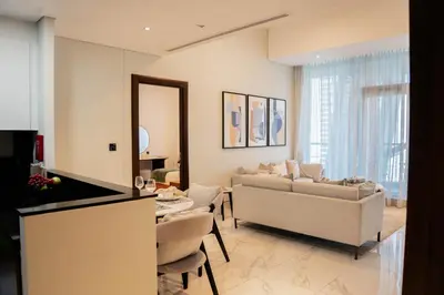a living room with a couch and a table at Stylish 1BR with Stunning Canal Views in Business Bay in Dubai