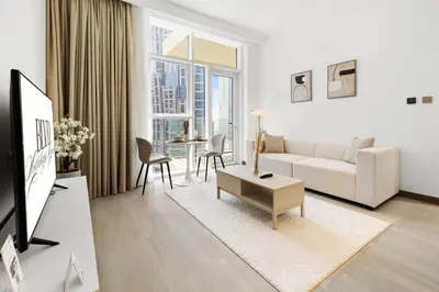 a white living room with a couch and a table at BLVD - Missoni Living - Close to Burj Khalifa in Dubai