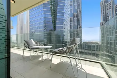 a balcony with two chairs and a table in front of a window at BLVD - Missoni Living - Close to Burj Khalifa in Dubai