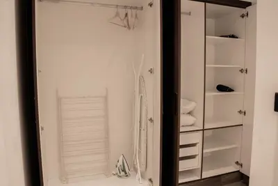 a bathroom with a closet with a mirror at Spacious 1BR in Business Bay l Pool, Gym & Parking in Dubai
