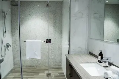 a bathroom with a shower and a sink at Spacious 1BR in Business Bay l Pool, Gym & Parking in Dubai