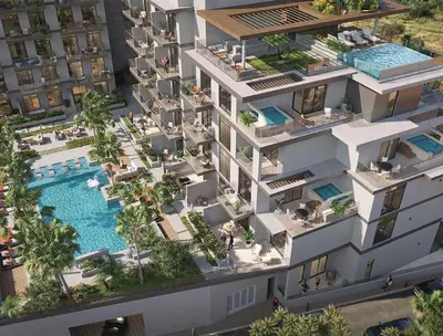 an aerial view of a building with a swimming pool at Oxford Luxury 1 bedroom & study in Dubai