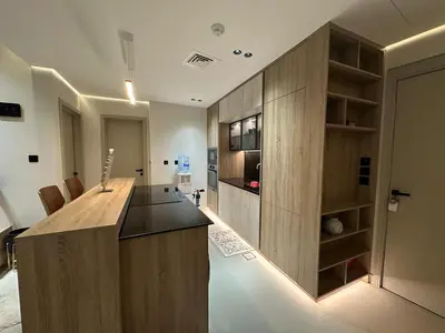 a kitchen with a wooden island in a room at Cozy Apartment Dubai Silicon Arch in Dubai