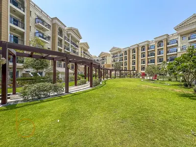 an empty lawn in front of a building at Bookable- Studio Resortz By Danube with Balcony in Dubai