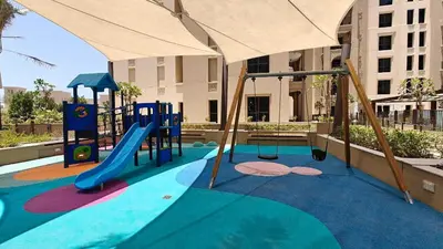 a playground with a slide and a slide at StayShort - MJL Apartment for 2 people near Water Parks in Dubai