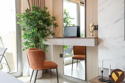 a living room with two chairs and a mirror at Vogue Marina JW Marriott with Direct Access to Marina Mall, Studio Apartment with Balcony and Marina Skyline View, Access to all Amenities in Dubai