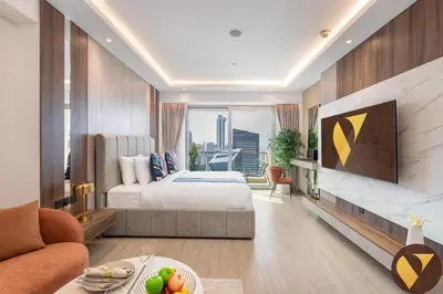 a hotel room with a bed and a tv at Vogue Marina JW Marriott with Direct Access to Marina Mall, Studio Apartment with Balcony and Marina Skyline View, Access to all Amenities in Dubai