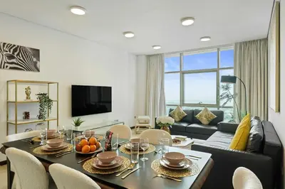 a living room with a table and a couch at Gorgeous 2BR in DIFC close to Metro & Dubai Mall in Dubai