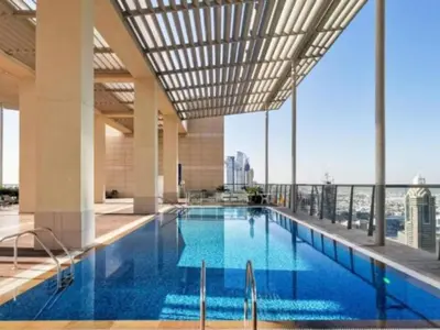 a large swimming pool with a view of the city at Gorgeous 2BR in DIFC close to Metro & Dubai Mall in Dubai