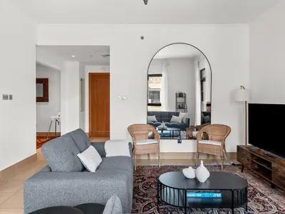 a living room with a couch and a table at Spacious 2BR Steps from Downtown in Dubai