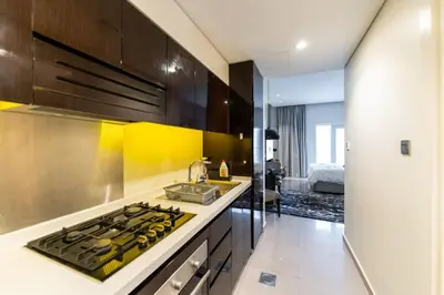 a kitchen with a sink and a stove top oven at Downtown Dubai Studio Apartment - High floor in Dubai